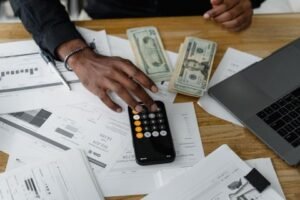 Small Business Websites 49 Accountant working through invoices with a calculator