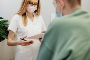 Small Business Websites 46 Clinic receptionist helping a patient at the front desk
