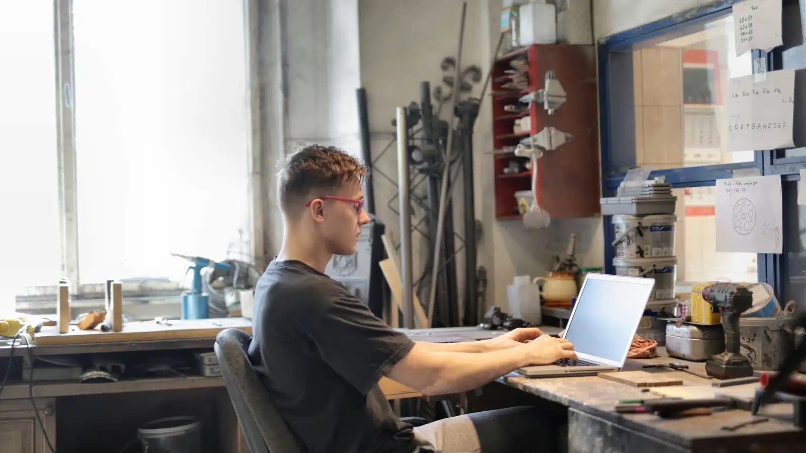 Small business owner in his workshop reviewing enquiries captured overnight by the website AI chatbot