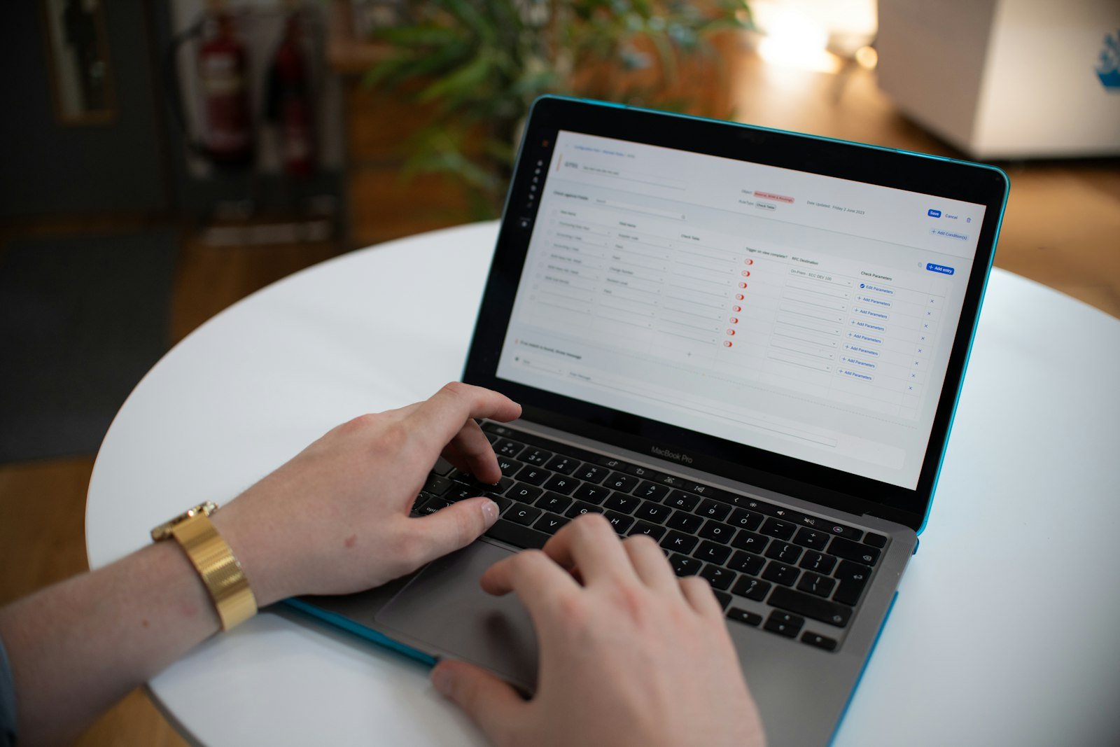 Hands typing spreadsheet data on a laptop, a task AI automation can take over